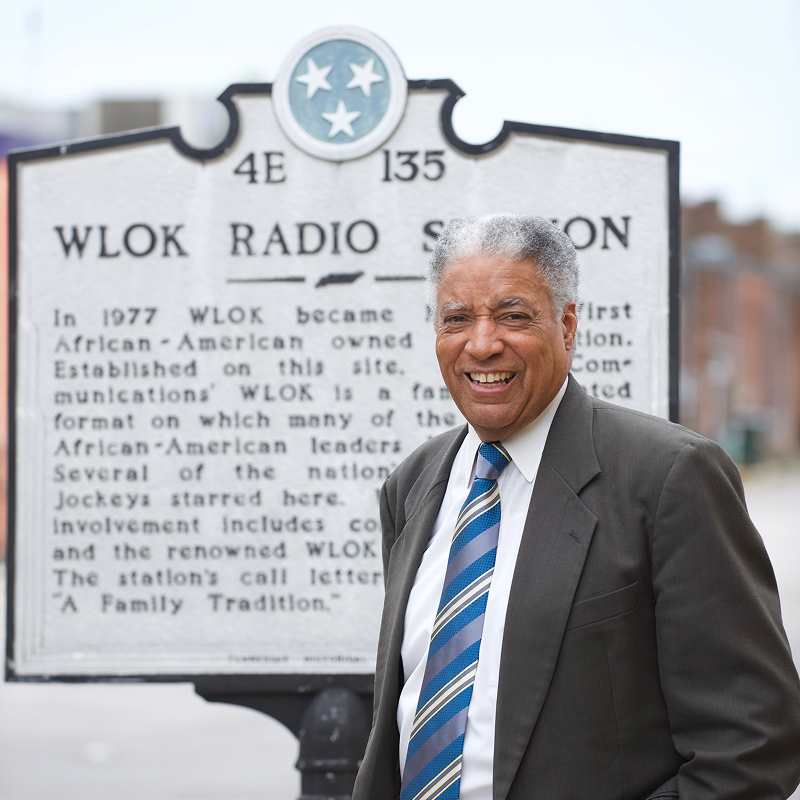 Art poses with a historic plaque dedicated to WLOK Radio Station