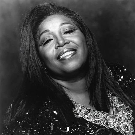 Denise smiles in a black and white photo